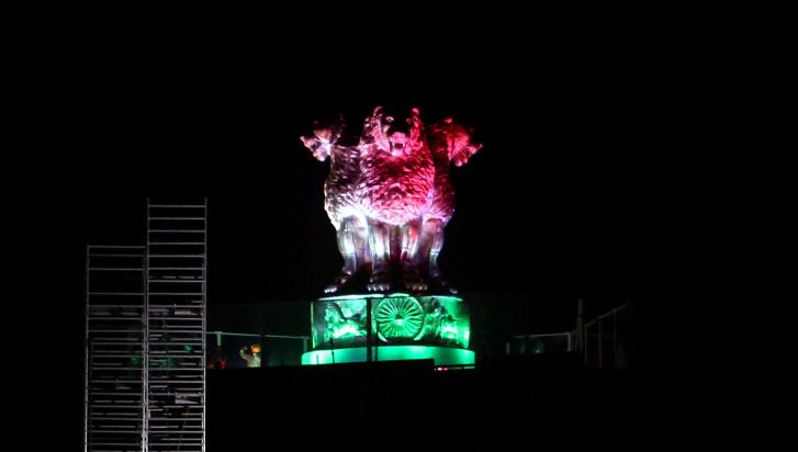 National Emblem cast on the roof of the New Parliament Building, lit up in tricolour on the eve of 76th Independence Day, in New Delhi on Sunday.