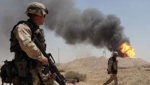 A US Army soldier watching a burning oil well at Rumaila oil field in Iraq in April 2003. Photo: US Navy