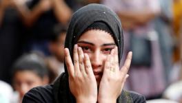 A Kashmiri woman wipes her tears while listening to a story of a Kashmiri man at a function in New Delhi where compatriots gathered to observe Eid. | Anushree Fadnavis/Reuters  