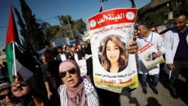 A demonstrator holding up a picture of Jordanian citizen Hiba Labadi, being held under administrative detention in Israel, during a protest calling for her release, in Ramallah in the occupied West Bank.