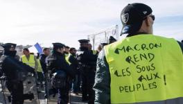 A Yellow Vests protester. The slogan on his vest says. "Macron, return the money to the people."