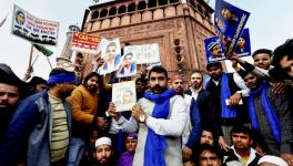 Bhim Army chief Chandrasekhar Azad holds a copy of the 'Indian Constitution' during a protest against Citizenship (Amendment) Act at Jama Masjid in New Delhi on Friday