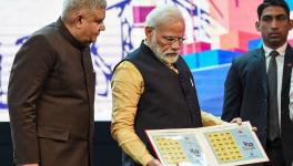 Prime Minister Narendra Modi releases a stamp in the presence of West Bengal Governor Jagdeep Dhankhar during an event to celebrate 150 years of Kolkata Port Trust. 