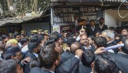 Sanjeev Lodhi (R with raised finger), joint secretary of the Lucknow bar association, along with other lawyers stage a protest after a crude-bomb exploded in the premises of a court, in Lucknow, Thursday