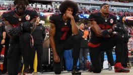 Colin Kaepernick of San Francisco 49ers and temmates kneel during the USA national anthem before an NFL match in 2016