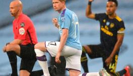 Manchester City and Arsenal FC players take the knee during their Premier League match