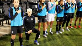 Megan Rapinoe of the US women's national team takes a knee in protest during the national anthem