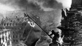 Yevgeny Khaldei’s iconic photo of the Red Army soldiers raising the Soviet flag on top of the Reichstag building in Berlin, May 1945. 