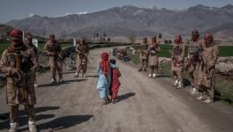Afghan children walk past a Taliban Red Unit, an elite force, Alingar district, Laghman province in eastern Afghanistan (File photo) 
