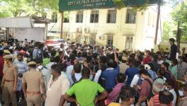 People awaiting Remdesivir medication gather as an announcement is made outside the Government Kilpauk Medical College Hospital in Chennai.