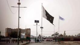 Flag of Afghan Taliban (in white) was raised on the Afghan side of the border with Pakistan at the major border crossing at Chaman, 14 July 2021.