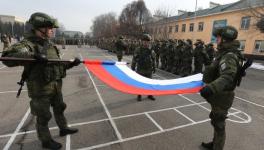 Russian servicemen fold the national flag during ceremony marking end of CSTO mission in Kazakhstan, Almaty, January 13, 2022