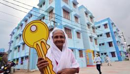 Sulaikha Beevi, who received the key from Pinarayi Vijayan, in front of the housing complex.