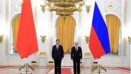 President Vladimir Putin (R) hosts Chinese President Xi Jinpi