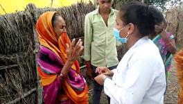 Uttar Pradesh, June 17 (ANI): A healthcare worker interacts with an elderly woman as people are against getting COVID-19 vaccination, in Chandauli 