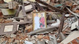 A framed photo of Mr Stalin and his wife lying at a demolished house in the eviction site
