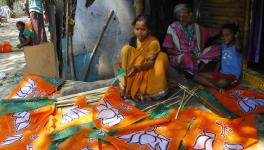 Workers preparing BJP symbol on flag sticks