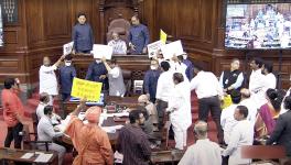 Opposition MPs holding placards stage a protest in the Well of Rajya Sabha over the inflation, 5% GST on essential items and other issues during the Monsoon Session of Parliament