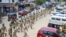 Police personnel conduct a march past in Puttur, Mangaluru, Thursday