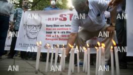  People lighting the candle during a prayer meeting for Father Stan Swamy outside a church, in Mumbai on Tuesday