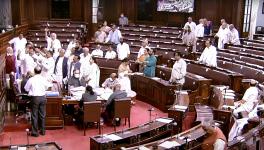 Opposition MPs shout slogans in the Well of Rajya Sabha while staging a protest over the price hike in fuel and essential commodities during the second part of the Budget Session of Parliament,