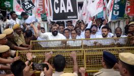 Police personnel stand guard as North-East Students Organisation (NESO) leaders and supporters stage a protest demanding scrapping of the Citizenship Amendment Act (CAA), in Guwahati.