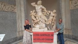 'Last Generation: No gas, No Coal' reads a banner held by climate activists who glued their hands to a statue at the Vatican Museums on August 18 