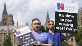 Nurses hold placards outside the Royal College of Nursing (RCN) in Victoria Tower Gardens, London, Wednesday July 21, 2021. 