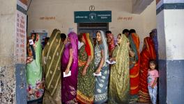  Women wait in a queue to cast their votes at a polling booth during the second and final phase of Gujarat Assembly elections, in Ahmedabad, Monday, Dec. 5, 2022.|