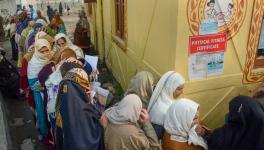 Srinagar: Women wait in a queue to register themselves for a government pension scheme, on a cold winter day, in Srinagar, Monday, Dec. 19, 2022.