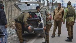 Security personnel check trunk of a car as security has been beefed up ahead of Union Home Minister Amit Shah's visit to Rajouri, in Poonch district, Thursday, Jan. 12, 2023.