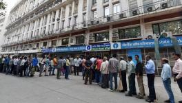 People queue up at out side of banks ATM to get money in New Delhi. 