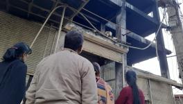 Two mothers, a father, and a sister stare into the dead building that took the lives of their loved ones.