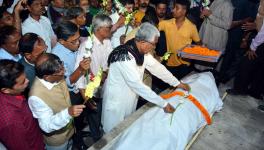 PBM Manik Sarkar Garlanding the mortal remains of martyrd CPIM activist Dilip Shukla Das in Agartala