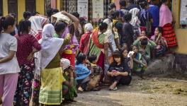 Voters wait in queues to cast their votes at a polling booth during the Meghalaya Assembly elections, in Ri Bhoi district, Monday, Feb. 27, 2023.