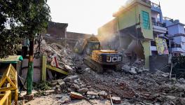 A Prayagraj Development Authority bulldozer demolishes Arms shopkeeper Safdar Ali's properties in the Chakiya area, in Prayagraj, Thursday, March 2, 2023. Ali is said to be a close aid of Atiq Ahmad.