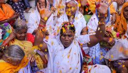 Widows participate in Holi celebrations at the ancient Gopinath Temple during an event organized by Sulabh International, in Vrindavan, Monday, March 6, 2023. (PTI Photo)