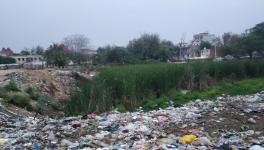 Asola's pond land, now a barren land, where some of the land has been captured by the locals and the rest is full of garbage.