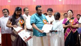 A beneficiary from Muthanga receiving the land title from minister for revenue K Rajan in Suthan Bathery on March 7. (Image courtesy: K Rajan/facebook)