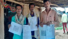 Bannu Vaskale, Dhansingh Richhu and another resident with their applications for land pattas under the Forest Rights Act (Photos - Mohammad Asif Siddiqui, 101Reporters)