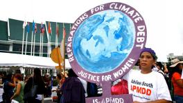 Rather than recognizing and paying a clear climate debt, we expend energy negotiating a loss and damage regime to be packaged as a humanitarian gesture. (Photo via Global Justice Now)