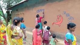 Rural women activists decorating walls of their mud house in WestBengal  with the left symbol after resurgence of the left inthe nomination filing period . 