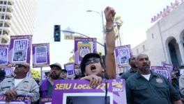 Workers shout slogans outside of City Hall Tuesday, Aug. 8, 2023, in Los Angeles. Thousands of Los Angeles city employees, including sanitation workers, engineers and traffic officers, walked off the job for a 24-hour strike alleging unfair labor practices. The union said its members voted to authorize the walkout because the city has failed to bargain in good faith and also engaged in labor practices that restricted employee and union rights. (AP Photo/Ryan Sun)