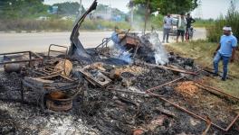 Locals look at burnt items at a shop which was set ablaze in a fresh case of communal violence in Gurgaon.