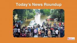 Commuters stand at one side of a road after it was flooded due to heavry rains, in Nagpur, Saturday, Sept. 23, 2023.