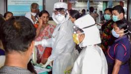 Family members of the patients admitted at the Kozhikode Medical College wear safety masks after the 'Nipah' virus outbreak, in Kozhikode. Image Courtesy: PTI
