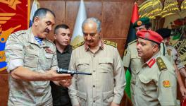 Russia’s Deputy Defence Minister Colonel-General Yunus-bek Yevkurov (L) presents a pistol as gift to Libyan military commander Field Marshal Khalifa Haftar (C), Benghazi, Libya, August 24, 2023
