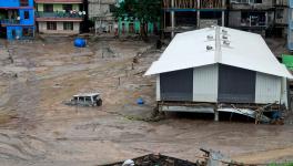  A vehicle is seen partially submerged in water after flash floods triggered by a sudden heavy rainfall swamped the Rangpo town in Sikkim, India, Thursday, Oct.5. 2023. 