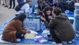  Polling officials collect EVMs and other election material at a distribution centre ahead of voting for Mizoram Assembly elections.