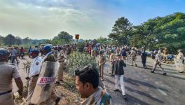 Police personnel disperse people gathered outside a manufacturing unit of Solar Industries after a blast occurred at the factory, at Bazargaon near Nagpur, Sunday, Dec. 17, 2023. At least nine people were killed, according to police.